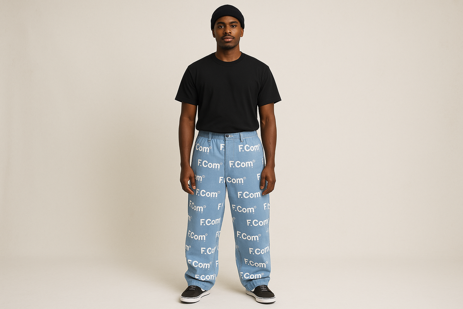 a dark skinned man wearing a black top and light blue trousers written F.Com in white linking to our leggings and trousers page.